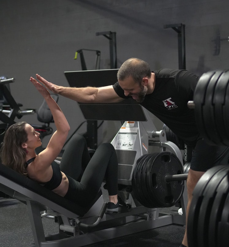 Personal trainer at Epic Athletic Center, high fives a client, Reston Gym Personal trainer at Epic Athletic Center, high fives a client, Reston Gym