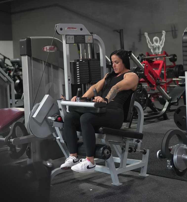 Woman working on a machine exercise at Reston Virginia gym Woman working on a machine exercise at Reston Virginia gym